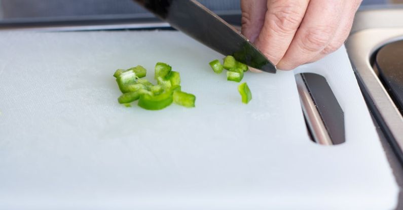 Car Preparation - Person Holding Green Vegetable on White Chopping Board