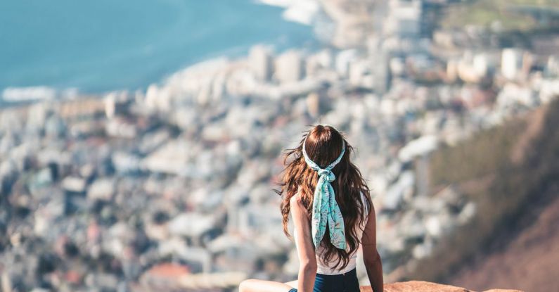 Scenic Overlooks - Woman iSitting On The Edge Of A Cliff