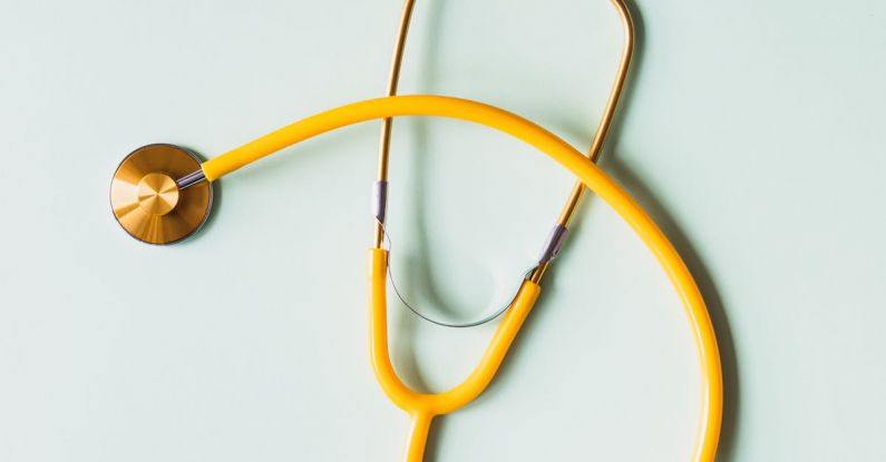Prevent Blisters - Top view of yellow medical stethoscope placed on white surface during coronavirus pandemic