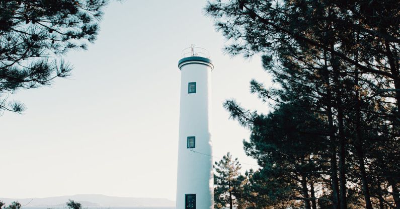 Navigate Trails - Lighthouse on slope surrounded by pines