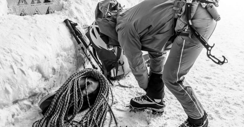 Winter Hiking - A man in a ski suit is holding a rope