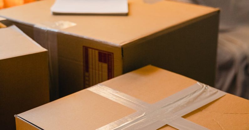 Day Pack - Carton boxes in living room near blinded widow