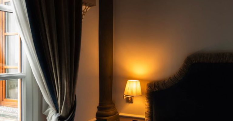 Hotel Reviews - A bed with a white comforter and a window