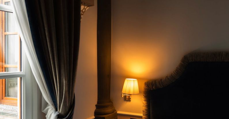 Hotel Reviews - A bed with a white comforter and a window