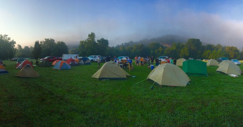 Festival Camping - Tents on Green Grass Field Near Mountain