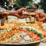 Festival Passes - Man Passing Food to Another Person on a Street Food Festival